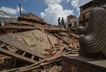 Two members of an emergency rescue team stand on top of the debris of the temples at Basantapur Durbar Square on April 27, 2015 in Kathmandu, Nepal.