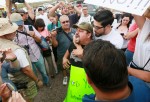 Pro-Immigration activist Ricardo Reyes yells at anti-immigration activists during a protest along Mt. Lemmon Road in anticipation of buses carrying illegal immigrants on Jully 15, 2014 in Oracle, Arizona. About 300 protesters lined the road waiting for a 