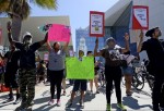 Demonstrators march in downtown Los Angeles protesting the police shooting death of 24-year-old Ezell Ford earlier in the week August 17, 2014, in Los Angeles, California. Several hundred protestors rallied in front of the Los Angeles Police Department he